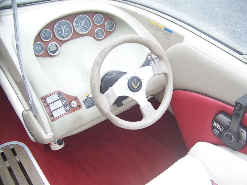 Slide: The Image of 1996 Bayliner 1850SS boat dashboard with steering wheel and control panel. - 4