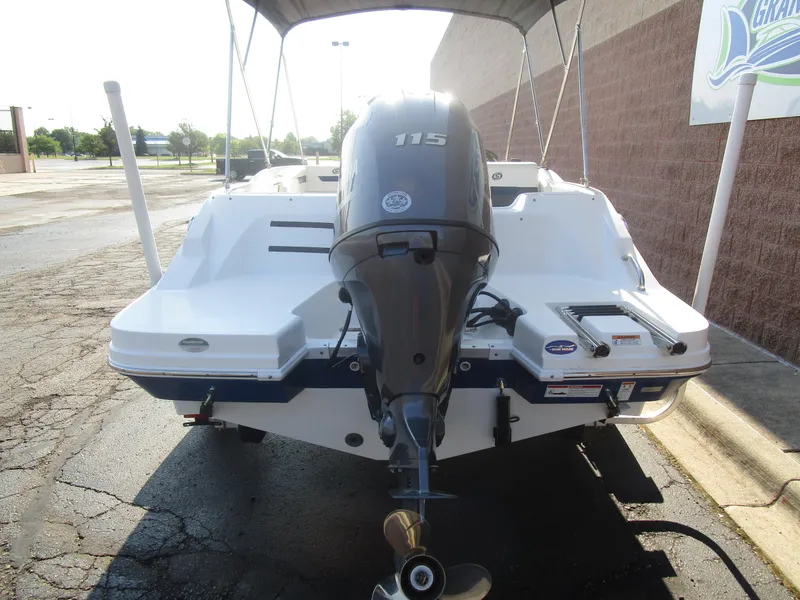 Slide: The Image of 2022 Hurricane SS 185 boat with outboard motor, parked outdoors. - 11