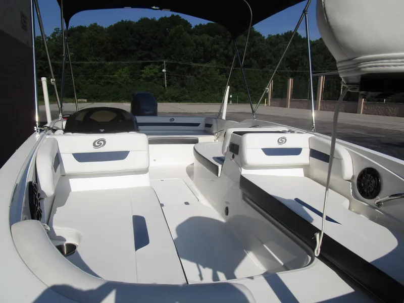 Slide: The Image of 2022 Hurricane SS 185 boat interior with white seating and canopy, parked outdoors. - 7