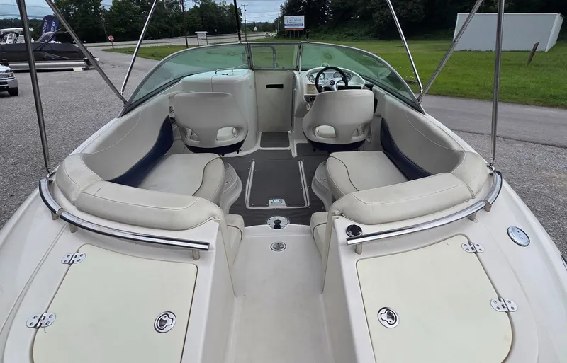 Slide: The Image of 2004 Monterey 233 Explorer boat interior with seating and steering wheel. - 4