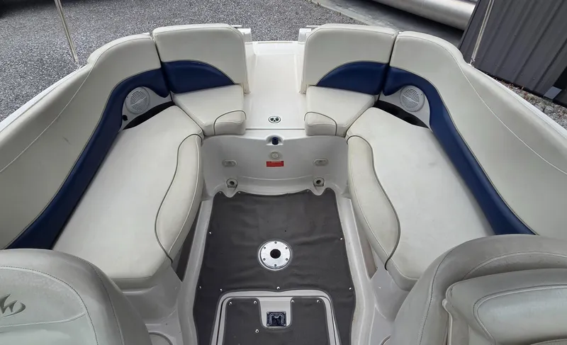 Slide: The Image of 2004 Monterey 233 Explorer boat interior with white and blue seating. - 5