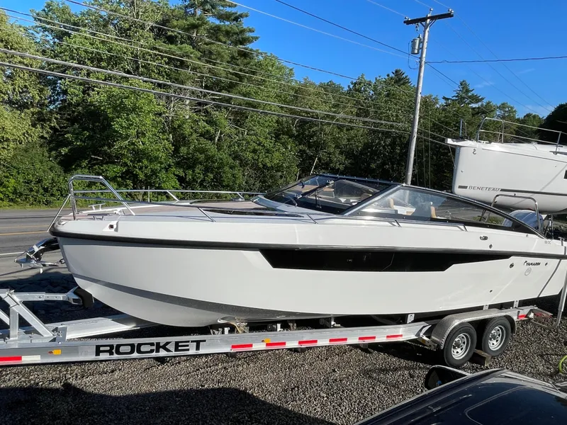 The Image of 2023 Yamarin 88 DC boat on trailer, surrounded by trees and clear blue sky. - 0