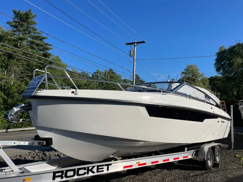 Slide: The Image of 2023 Yamarin 88 DC boat on trailer, for sale under clear blue sky. - 1