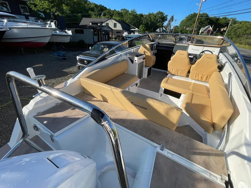 Slide: The Image of 2023 Yamarin 88 DC boat with tan seating, docked outdoors on a sunny day. - 12