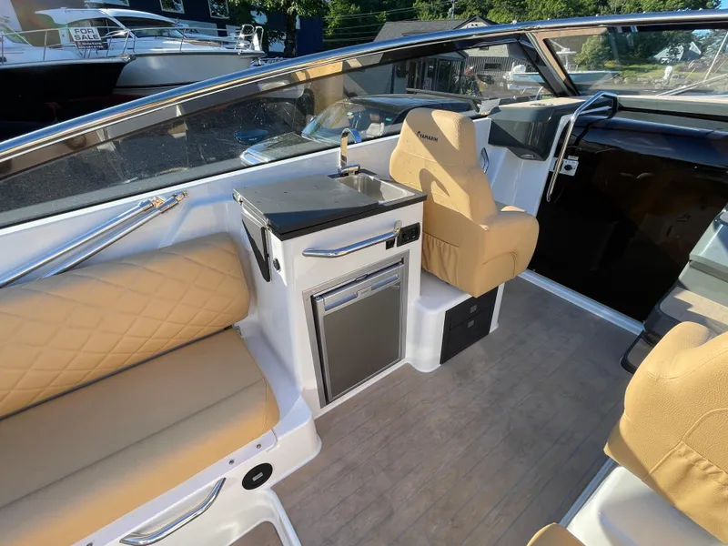 Slide: The Image of Interior of 2023 Yamarin 88 DC boat with beige seating and compact kitchenette. - 16