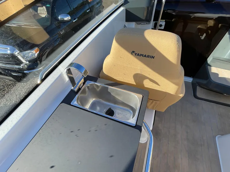 Slide: The Image of 2023 Yamarin 88 DC boat interior with sink and beige seat. - 18