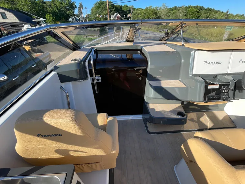 Slide: The Image of 2023 Yamarin 88 DC boat interior with tan seats and modern dashboard. - 19