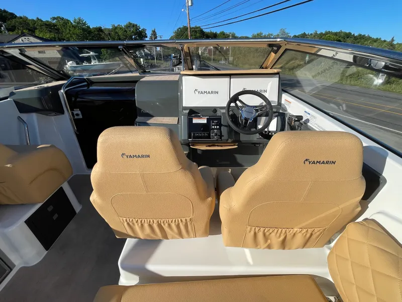 Slide: The Image of Interior view of 2023 Yamarin 88 DC boat with tan seats and modern dashboard. - 20