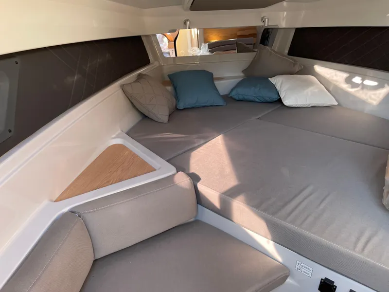 Slide: The Image of Cozy cabin interior of 2023 Yamarin 88 DC boat with cushions and soft lighting. - 24