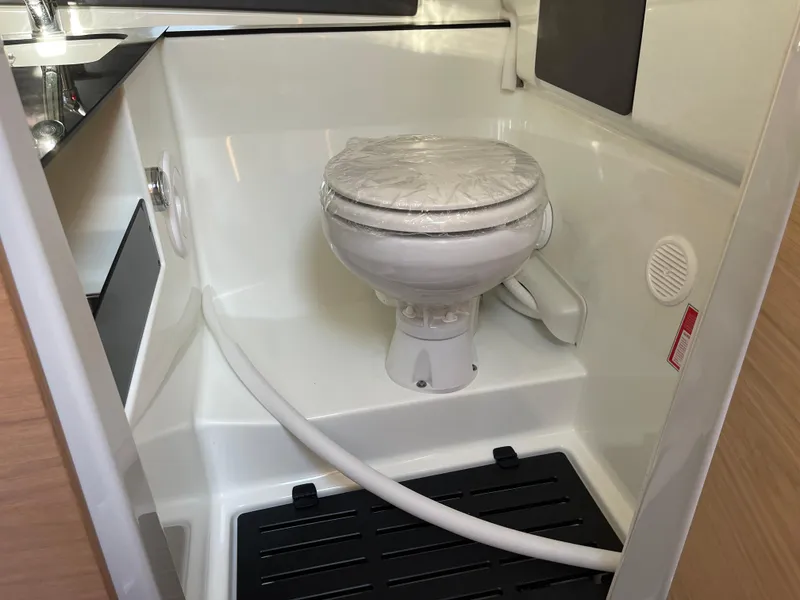 Slide: The Image of 2023 Yamarin 88 DC boat interior with compact marine toilet. - 27