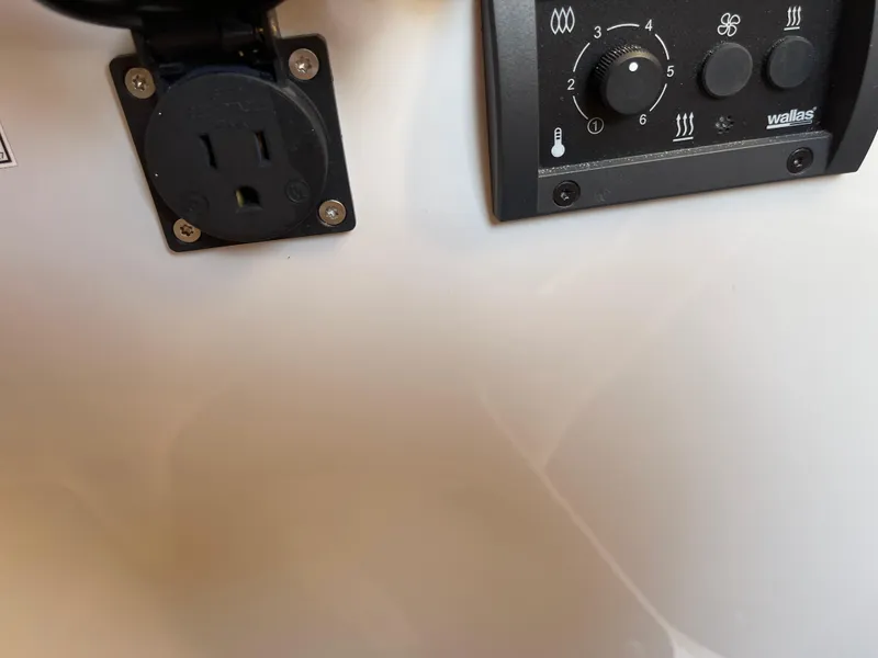 Slide: The Image of Control panel and outlet on 2023 Yamarin 88 DC boat interior. - 30