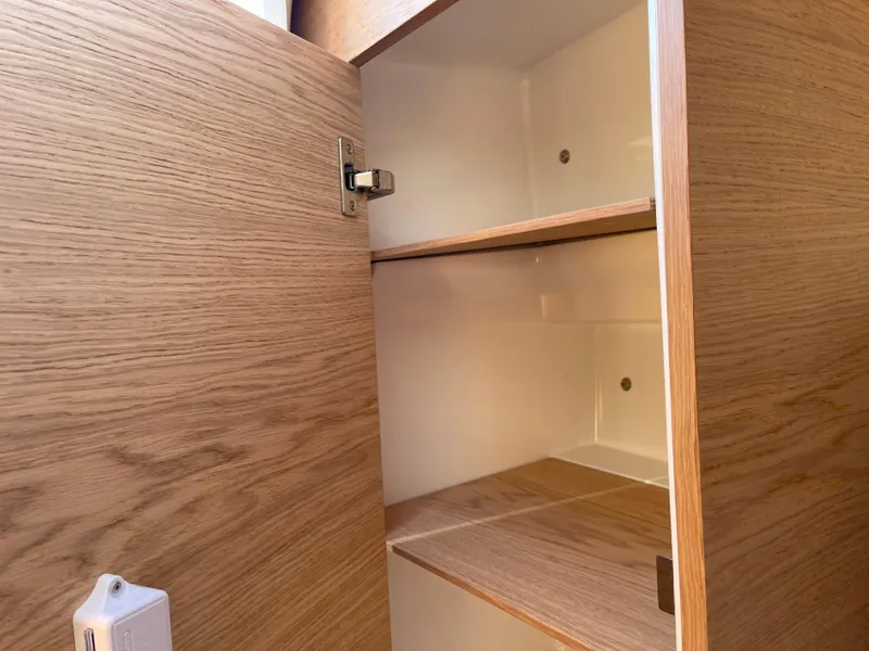 Slide: The Image of Open wooden cabinet with shelves inside Yamarin 88 DC, 2023 model. - 32