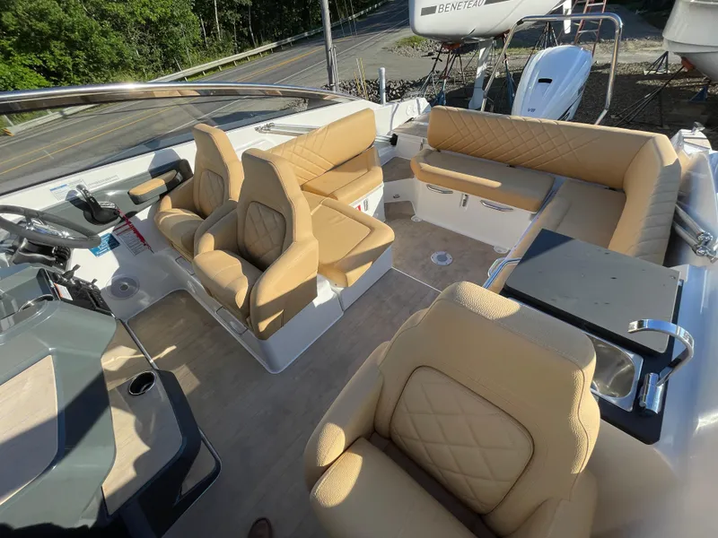 Slide: The Image of 2023 Yamarin 88 DC boat interior with beige seating and modern dashboard. - 35