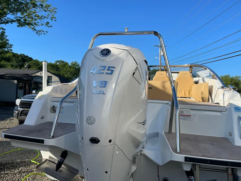Slide: The Image of 2023 Yamarin 88 DC boat with Yamaha 425 V8 engine, docked under clear blue sky. - 5