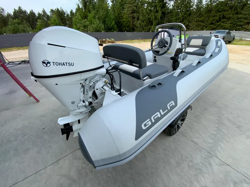 Slide: The Image of 2026 Gala A330L inflatable boat with Tohatsu outboard motor, parked outdoors. - 3