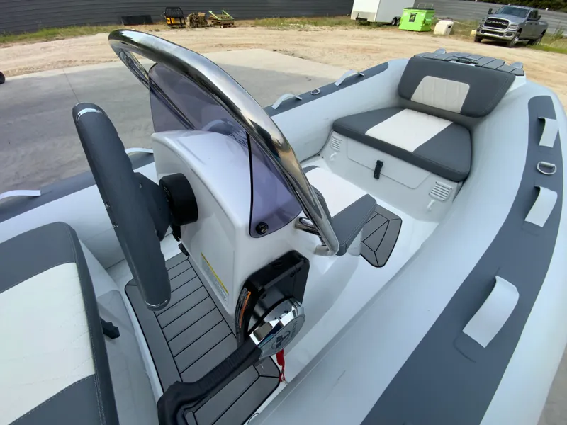 Slide: The Image of 2026 Gala A330L inflatable boat interior with steering console and seating. - 5