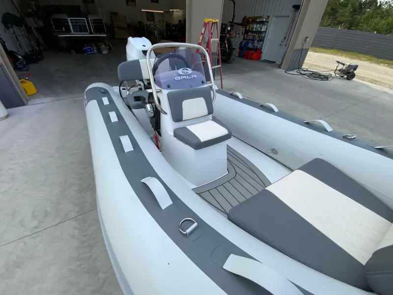 Slide: The Image of 2026 Gala A330L inflatable boat in a garage, featuring sleek design and modern seating. - 6
