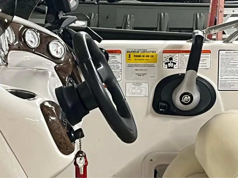 Slide: The Image of Steering console of a 2010 Tahoe 195 Deckboat with gauges and controls. - 6