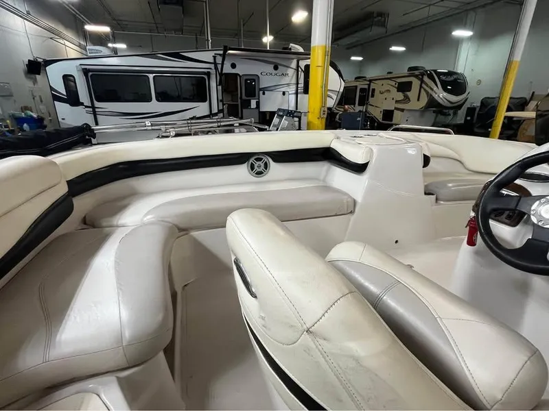 Slide: The Image of Interior of a 2010 Tahoe 195 Deckboat with white seating in a showroom. - 7