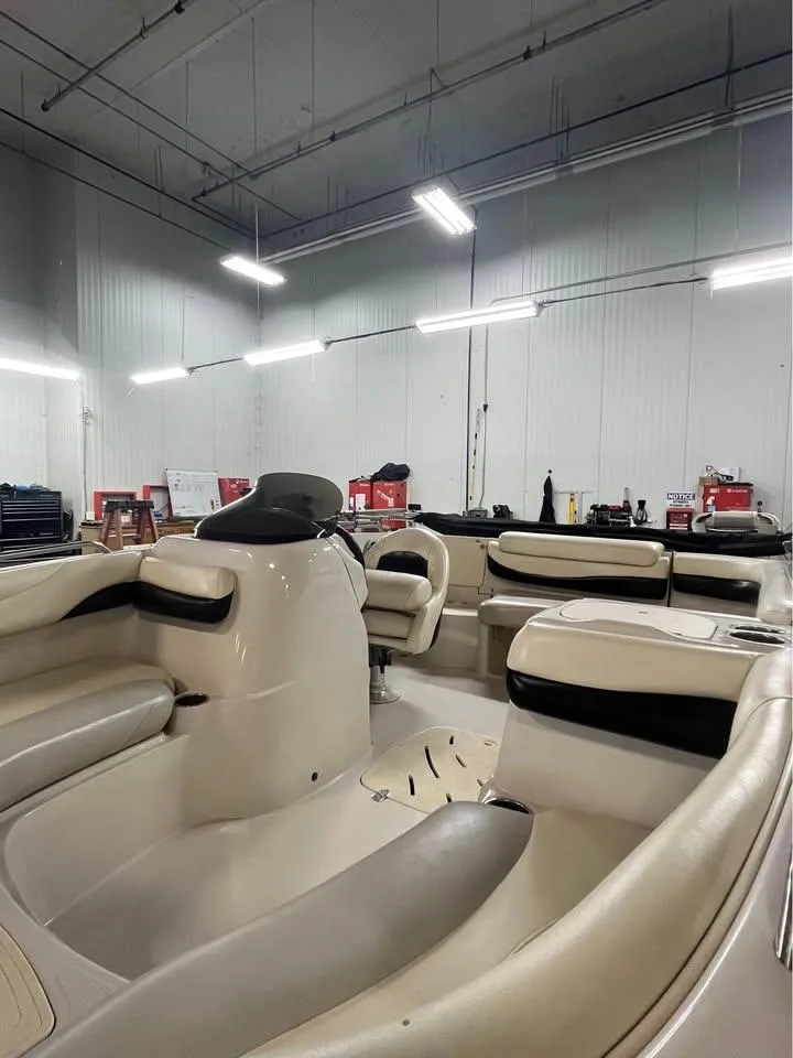 Slide: The Image of Interior of a 2010 Tahoe 195 Deckboat in a well-lit garage. - 9