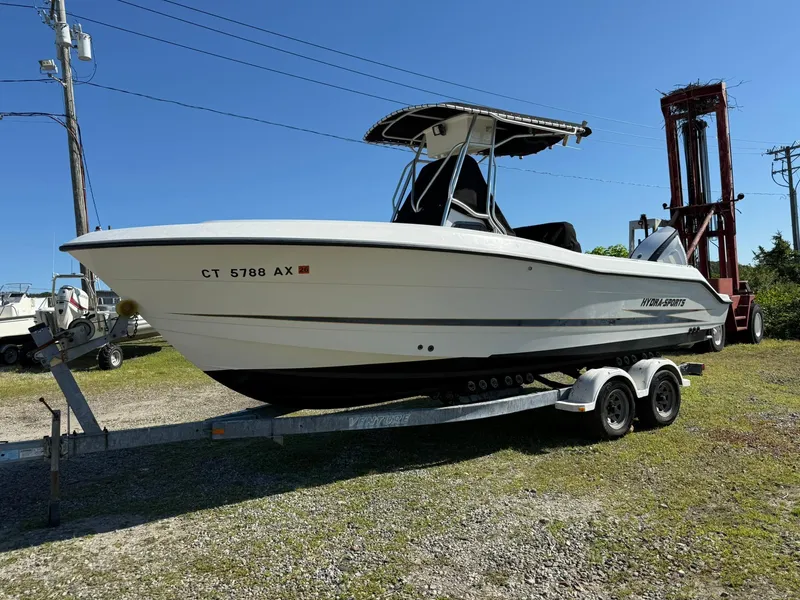 Slide: The Image of 2001 Hydra-Sports 2390 CC Vector boat on trailer, parked outdoors under clear blue sky. - 19