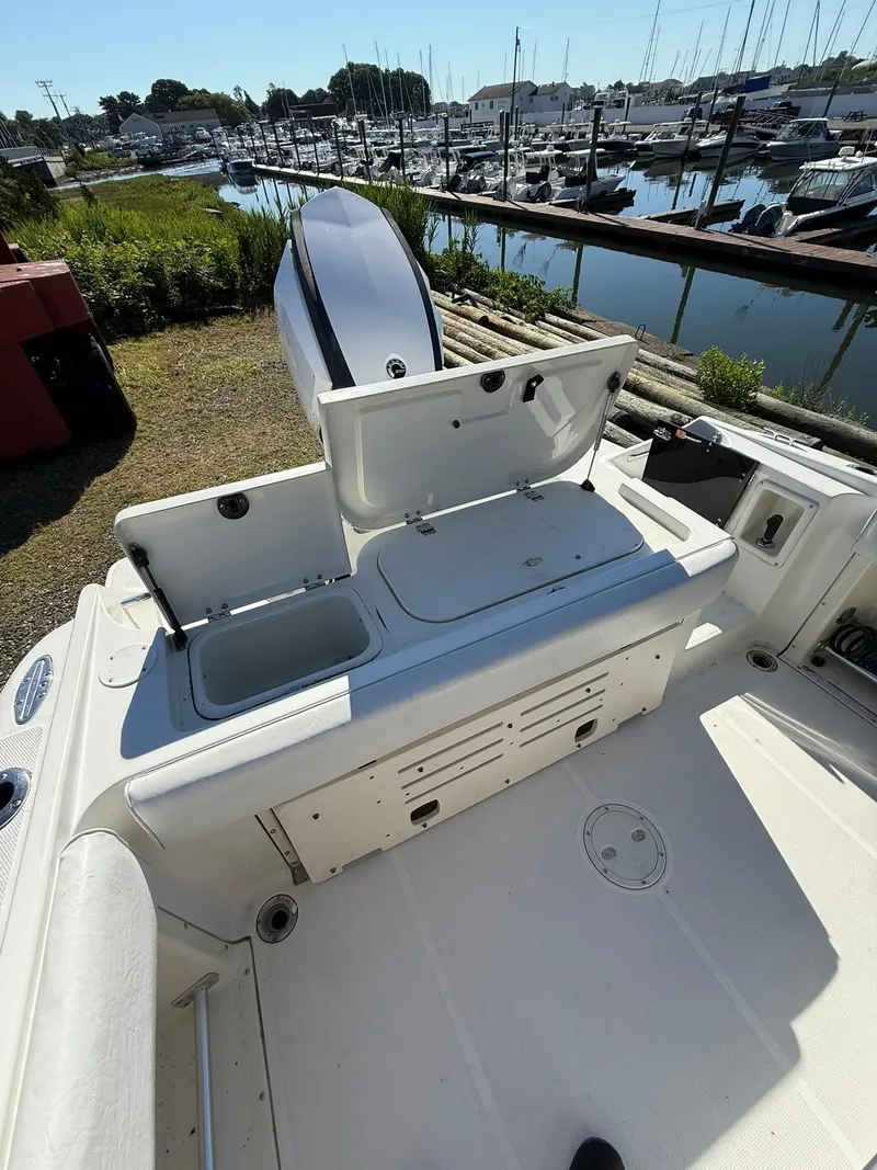 Slide: The Image of 2001 Hydra-Sports 2390 CC Vector boat interior with open storage compartments, docked at marina. - 7