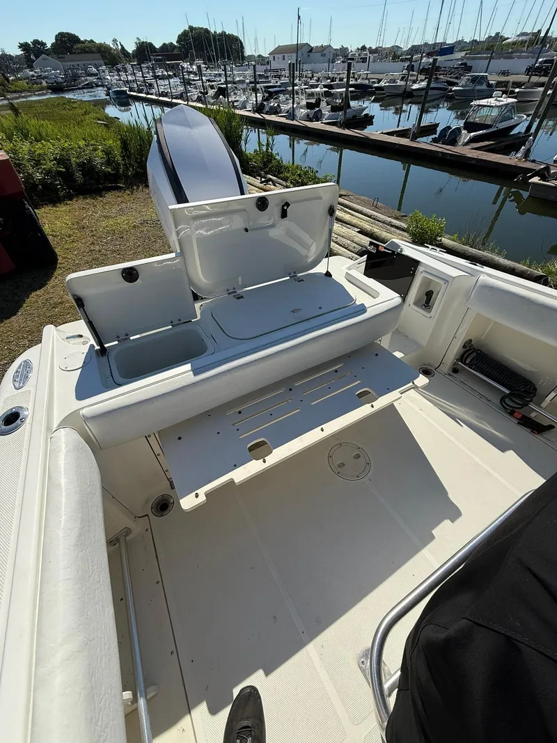 Slide: The Image of 2001 Hydra-Sports 2390 CC Vector boat interior with open storage compartments, docked at marina. - 8