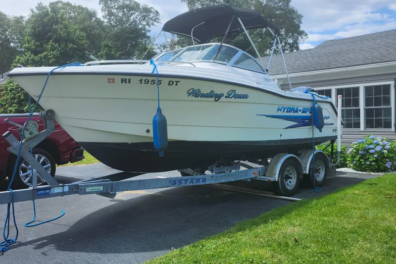Slide: The Image of 2006 Hydra-Sports 202 DC boat on trailer in driveway, surrounded by greenery. - 5