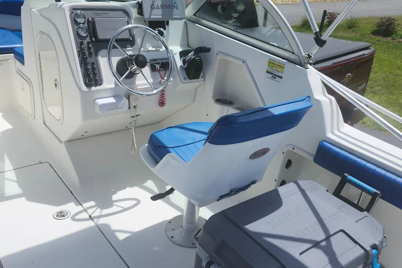 Slide: The Image of 2006 Hydra-Sports 202 DC boat cockpit with steering wheel and blue seating. - 9