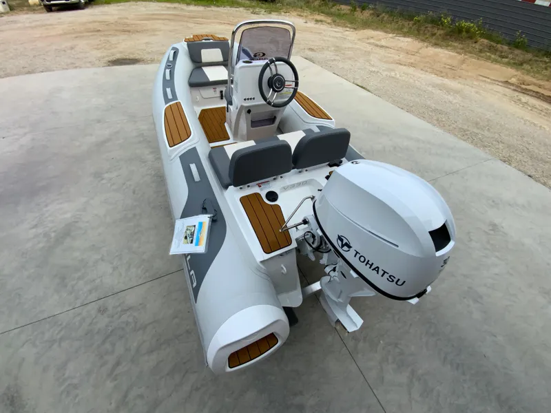 Slide: The Image of 2026 Gala V330 boat with Tohatsu engine, featuring sleek design and wooden accents. - 1