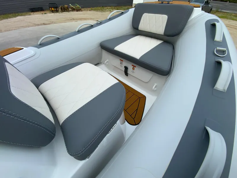 Slide: The Image of Interior of 2026 Gala V330 boat with cushioned seating and modern design. - 10