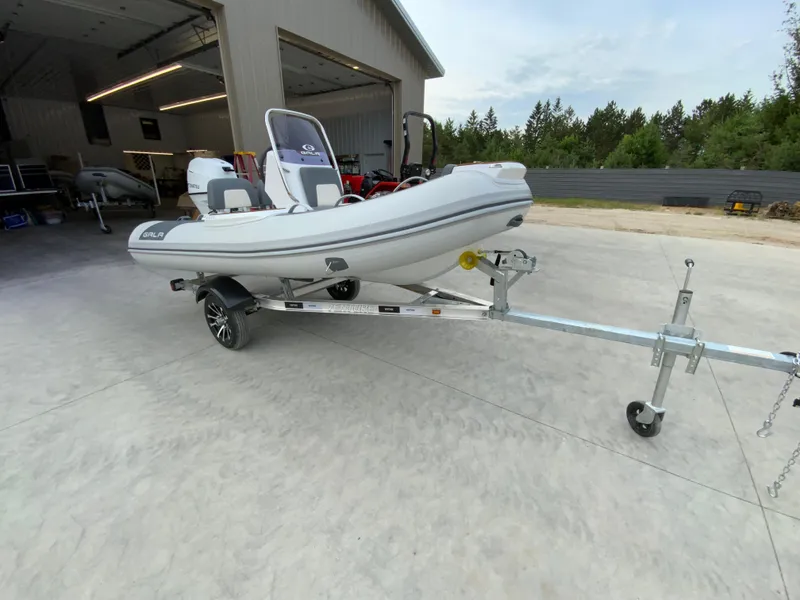 Slide: The Image of 2026 Gala V330 inflatable boat on trailer, parked outside a garage. - 6