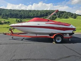 Slide: The Image of 2008 Crownline 19 SS boat on trailer, red and white, scenic background. - 10