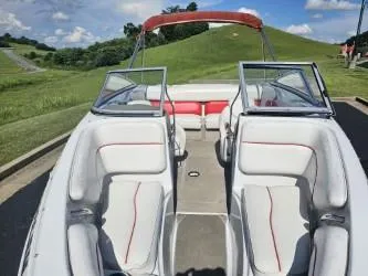 Slide: The Image of 2008 Crownline 19 SS boat with open seating, red accents, and scenic background. - 6