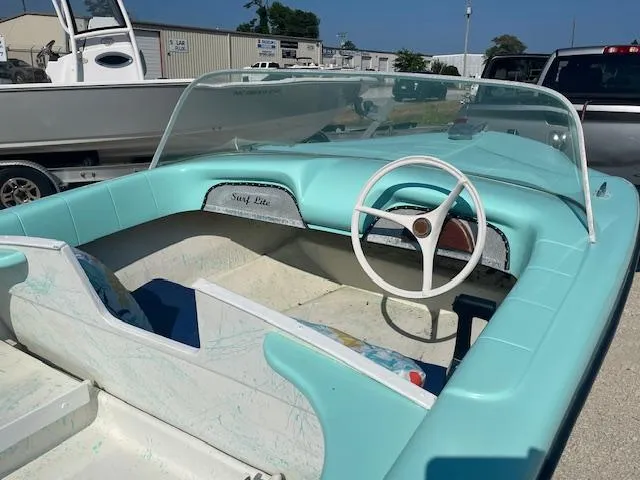 Slide: The Image of 1959 Glastron 15' Surflite boat with turquoise interior and classic steering wheel. - 5