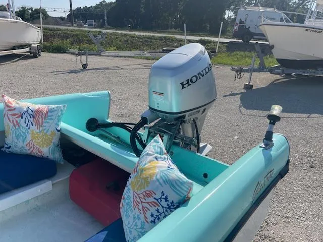 Slide: The Image of 1959 Glastron 15' Surflite boat with Honda outboard motor and colorful cushions. - 7