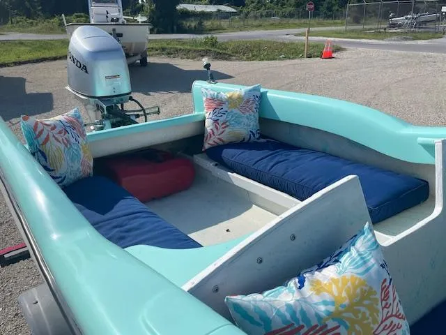 Slide: The Image of 1959 Glastron 15' Surflite boat with colorful cushions and Honda outboard motor. - 10