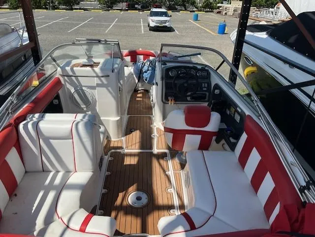 Slide: The Image of 2008 Yamaha Boats SX230 HO interior with red and white seating, parked in a lot. - 2