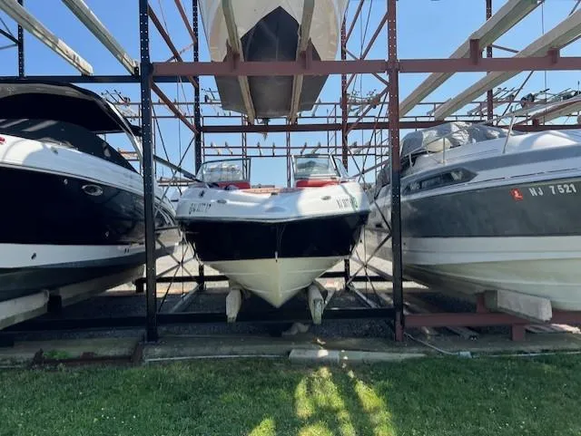 Slide: The Image of 2008 Yamaha Boats SX230 HO stored on a rack between two other boats. - 4