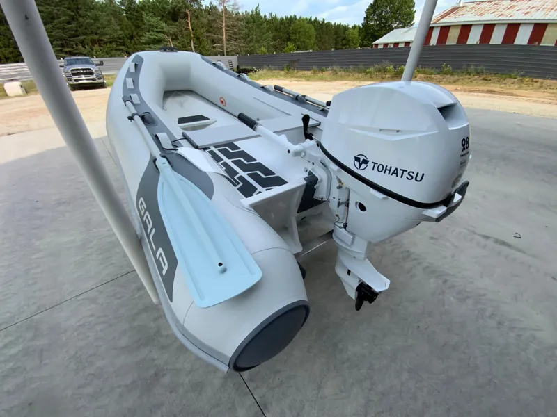 Slide: The Image of Inflatable Gala A300 boat with Tohatsu motor, 2026 model, parked outdoors. - 3