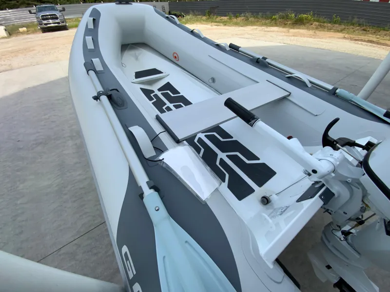 Slide: The Image of 2026 Gala A300 inflatable boat with motor, parked on concrete surface. - 4