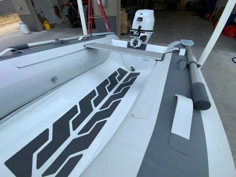 Slide: The Image of 2026 Gala A300 inflatable boat with motor in a garage setting. - 6