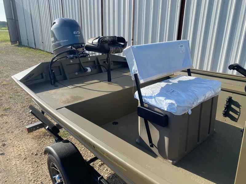 Slide: The Image of 2025 G3 Gator Tough 17 CCJ boat with Yamaha 65 engine, parked outdoors. - 7