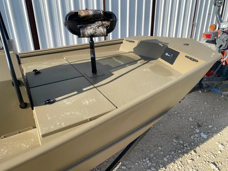 Slide: The Image of 2025 G3 Gator Tough 17 CCJ boat with camo seat, parked on gravel. - 8