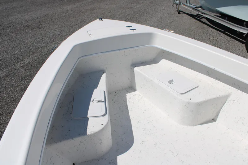 Slide: The Image of 2025 C-Hawk 19CC boat interior with storage compartments, white deck, and clean design. - 12