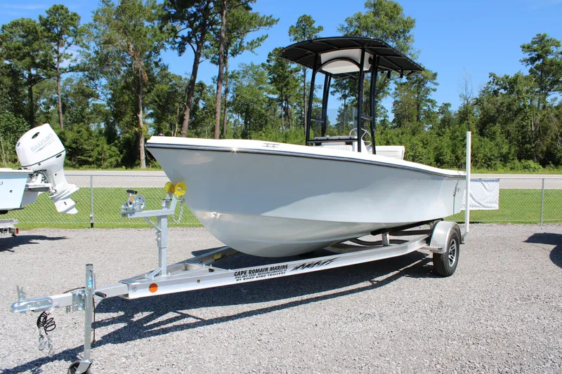 Slide: The Image of 2025 C-Hawk 19CC boat on trailer, parked outdoors with trees in the background. - 5