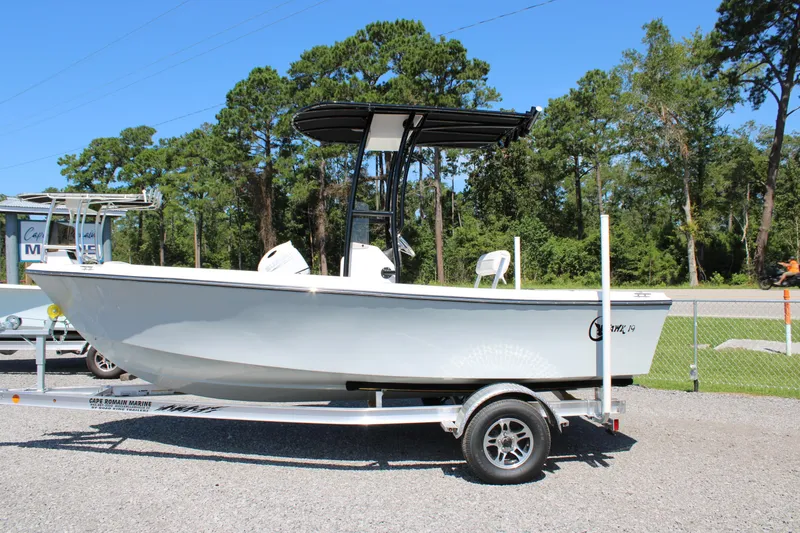 Slide: The Image of 2025 C-Hawk 19CC boat on trailer, parked outdoors with trees in background. - 6