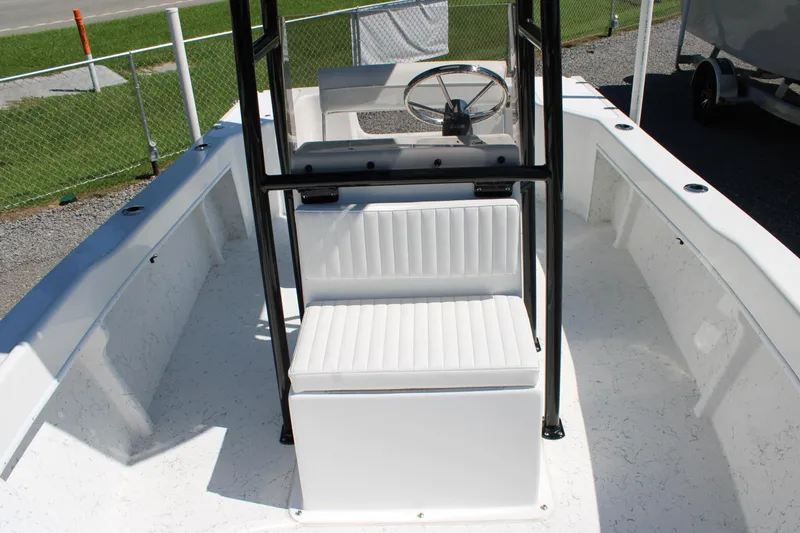 Slide: The Image of 2025 C-Hawk 19CC boat interior with white seating and steering console. - 18