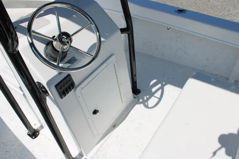Slide: The Image of 2025 C-Hawk 19CC boat console with steering wheel and control panel. - 22