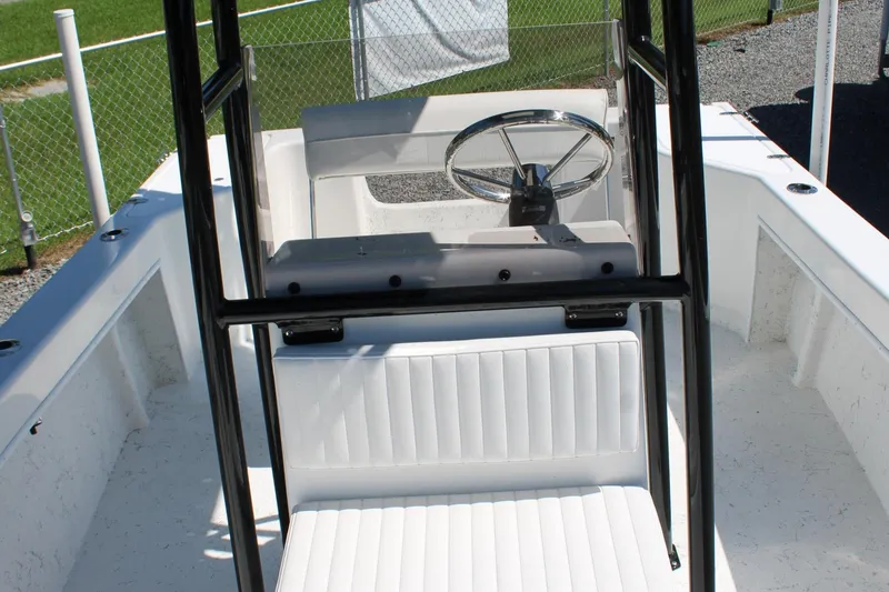 Slide: The Image of 2025 C-Hawk 19CC boat interior with steering wheel and seating. - 23